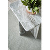 High-angle shot emphasizing the smooth beveled edges of the square marble top and the sturdy pedestal support