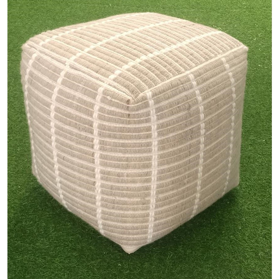 Lifestyle shot of the Kenniston woven pouf styled on a green lawn highlighting its textured fabric and durable form