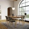 Real-world showroom perspective featuring the natural wood table styled with neutral decor and upholstered seating