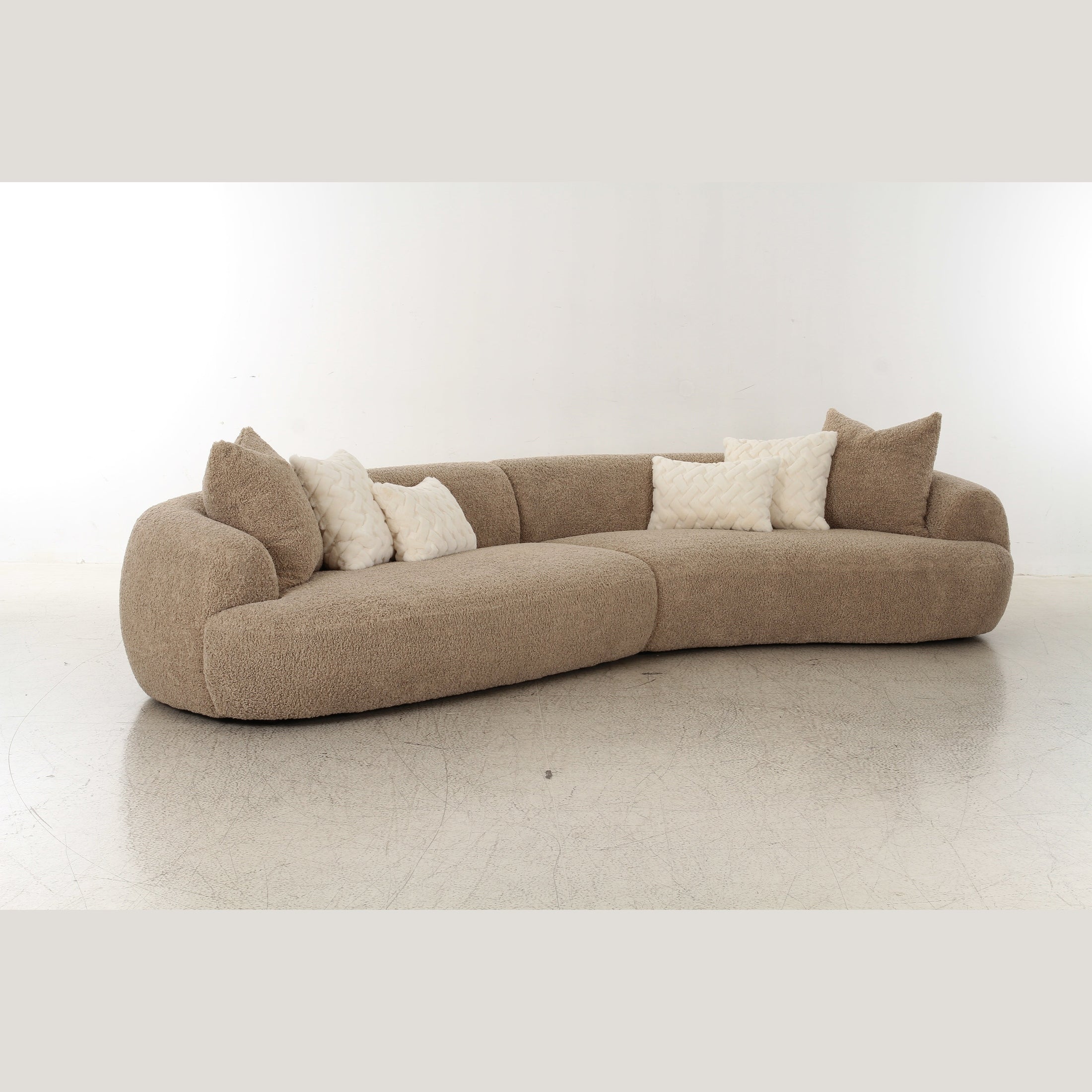 Front view of Klint curved bouclé sectional sofa in taupe