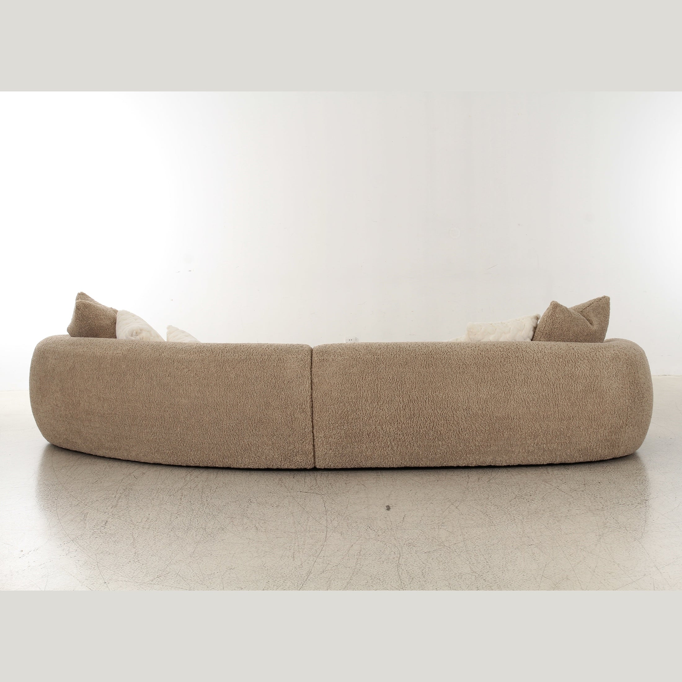 Front view of Klint curved bouclé sectional sofa in taupe