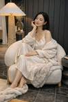 Lifestyle shot of the Konsta chair styled in a moody modern room with a person seated to demonstrate the oversized deep-seated comfort
