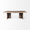 Front view of the Konstantin rectangular dining table featuring a medium brown wood finish with a natural live edge and thick slab pedestal legs