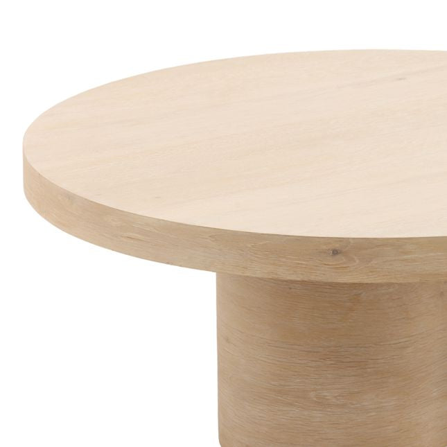 Close-up shot focusing on the smooth light oak wood grain and the rounded edges of the Kyrell coffee table