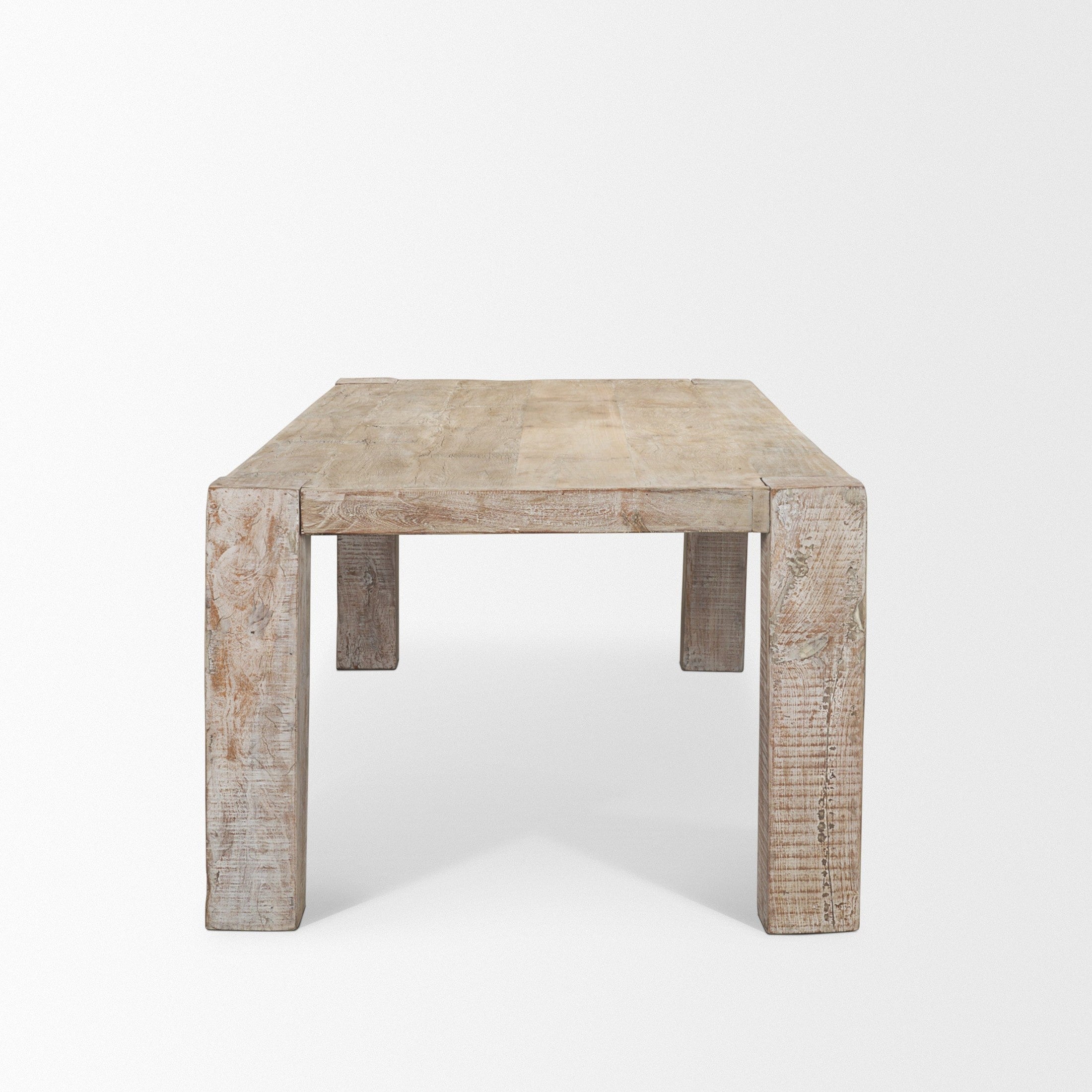 Front view of the 94-inch McArthur dining table featuring a whitewash finish and a substantial Parsons-style reclaimed wood construction