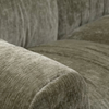 Detailed perspective of the deep-seated cushion and the vertical channeled corduroy fabric in olive green