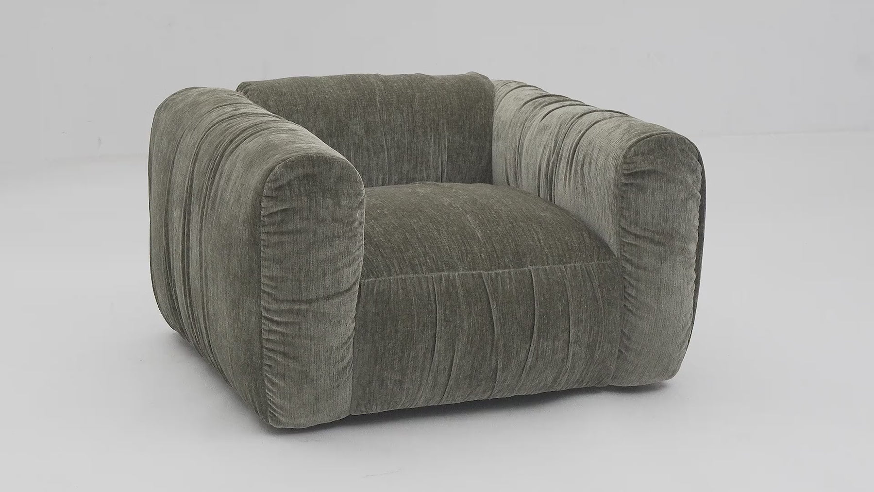 Front view of the Larvik accent chair in olive green corduroy featuring a slouchy oversized design and deep vertical pleating
