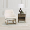 The Las Vegas rocker styled in a bright minimalist room next to a dark wood side table and modern lamp