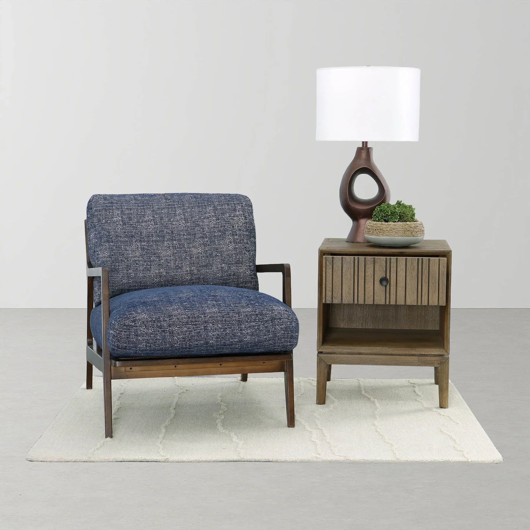 The blue Lawrence chair styled in a minimalist room setting
