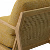 Detailed view of the natural cane back on the light wood frame