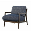Three-quarter view highlighting the blue upholstery and curved wooden arms