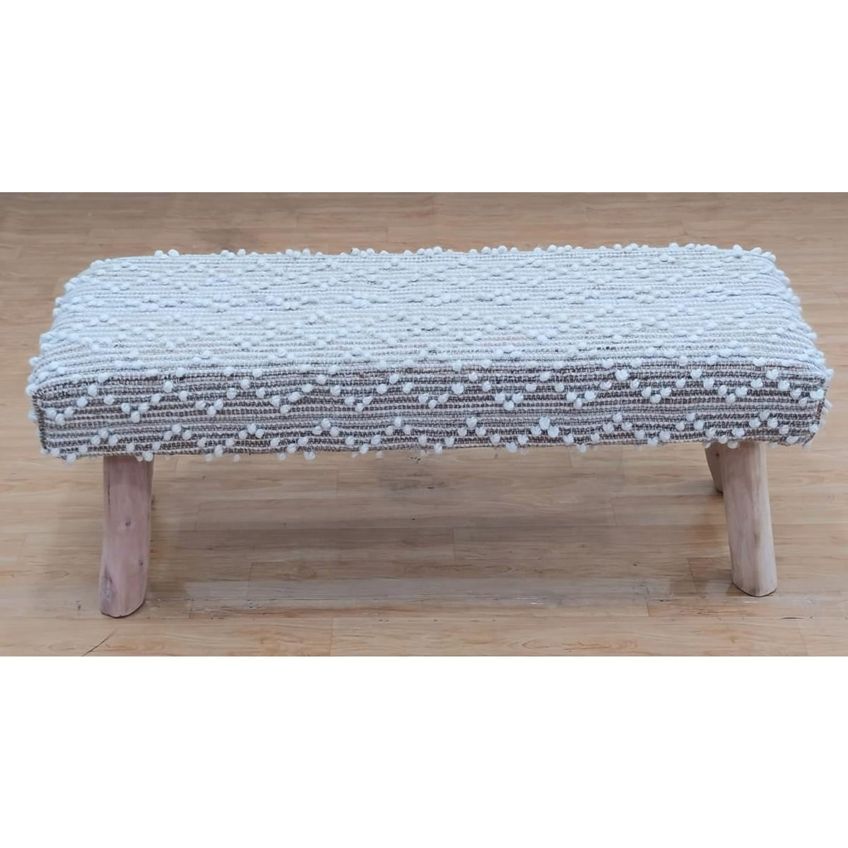 Front view of the Leeward bench featuring ivory and natural textured weaving with a geometric diamond pattern and organic wood legs