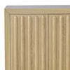 Close-up shot focusing on the rhythmic vertical fluting and the warm natural tones of the light oak cabinet door