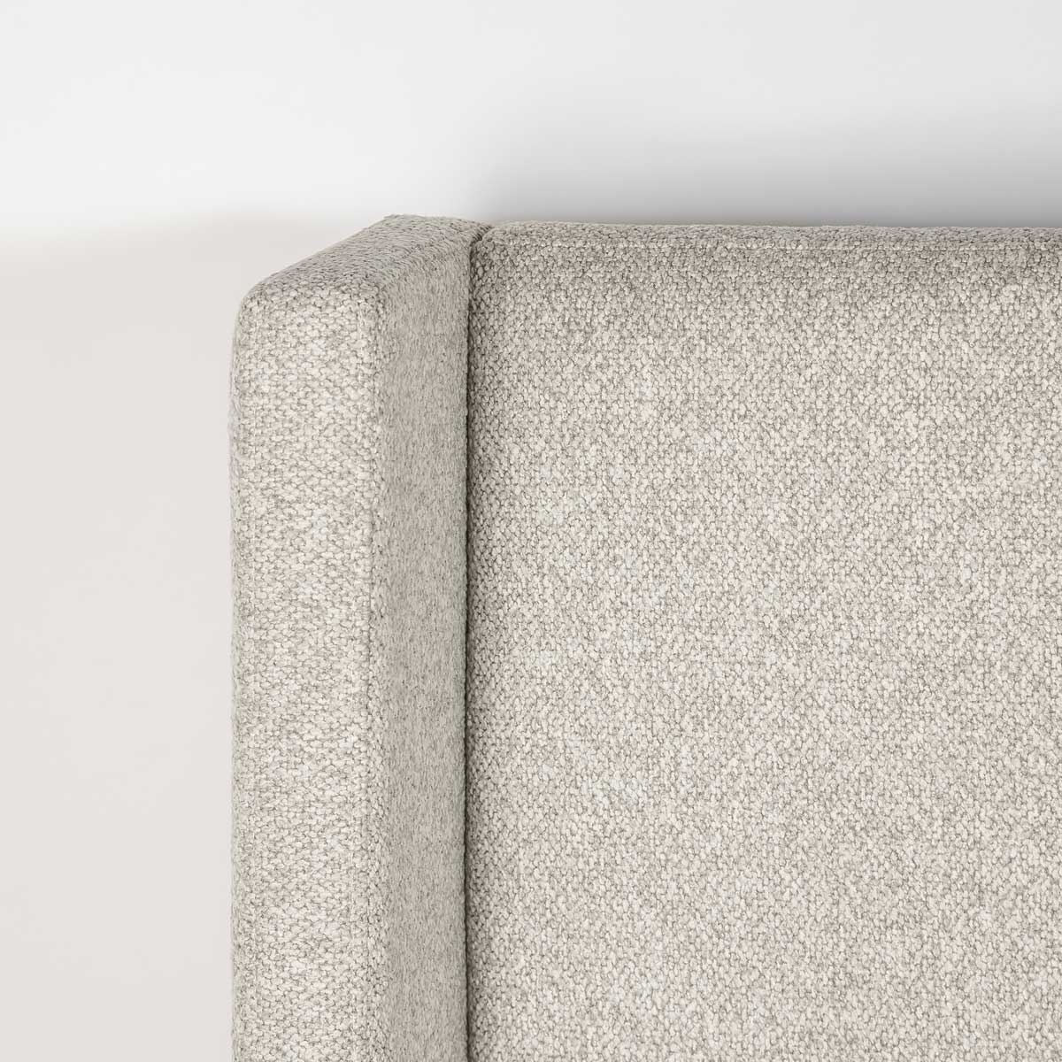 Close-up shot focusing on the high-quality tailoring and seamless fabric transition of the dune wingback headboard