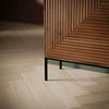 Low-angle perspective shot highlighting the texture of the door panels and the industrial metal leg construction