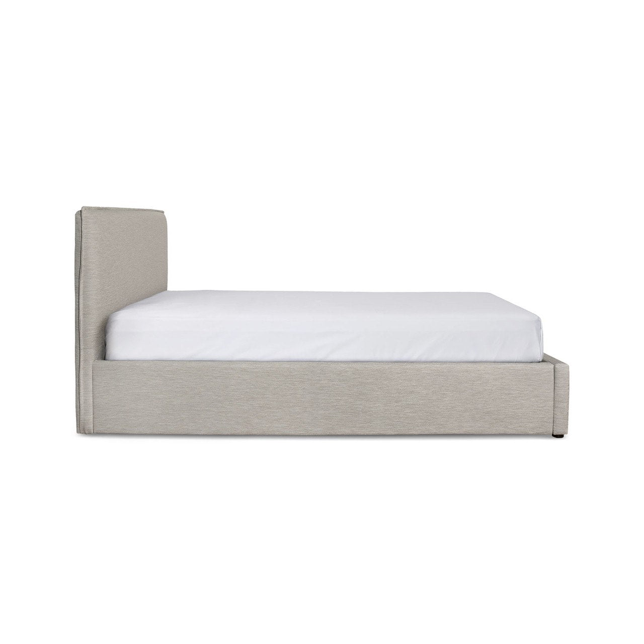 Side profile view showcasing the slender depth of the cushioned headboard and the flush floor-to-base construction