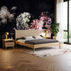 Lifestyle shot featuring the Lumina nightstand in a dark, moody bedroom setting with a large floral mural and coordinating bed