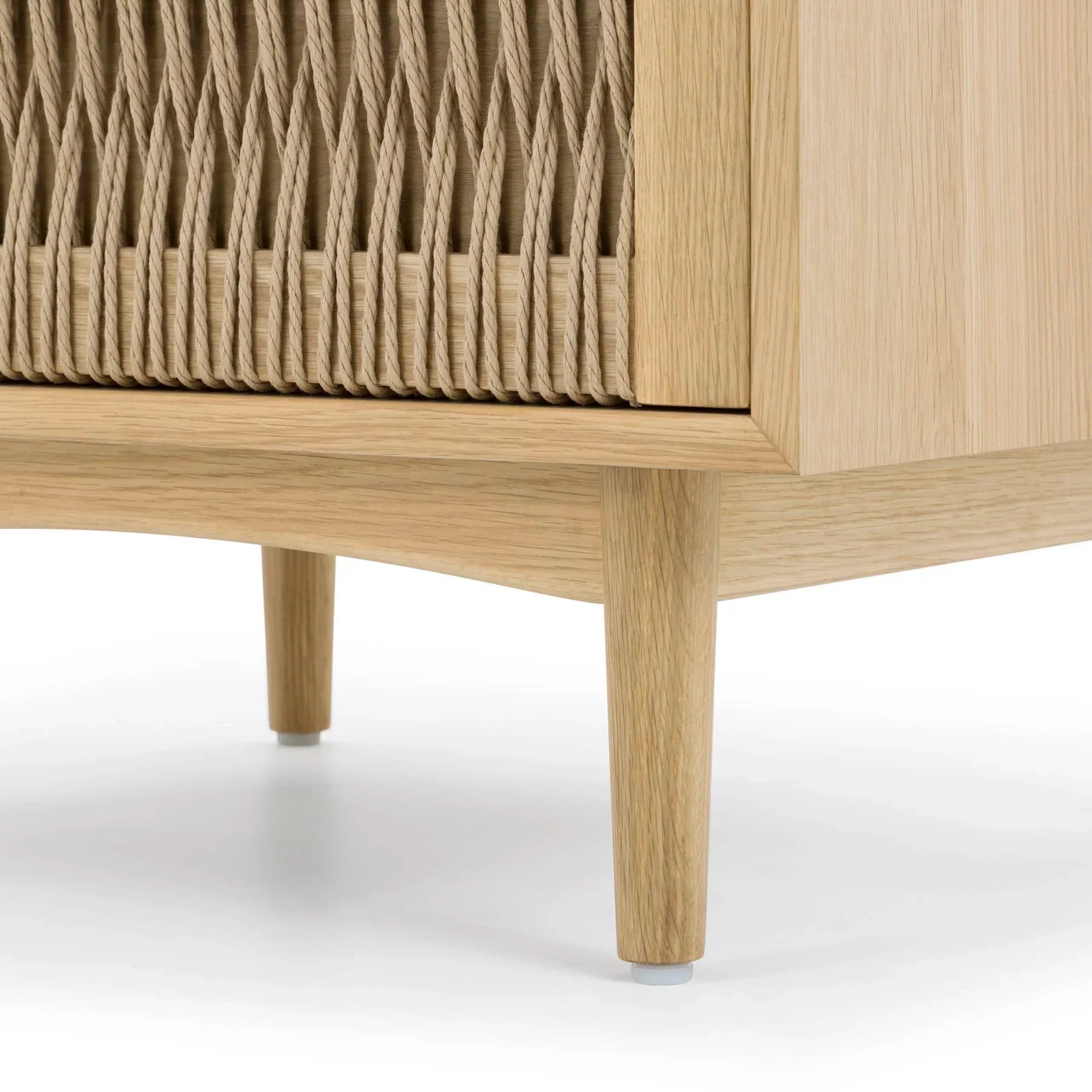Front view of the Lumina nightstand featuring a light natural ash finish, an open upper shelf, and a unique woven rope drawer front