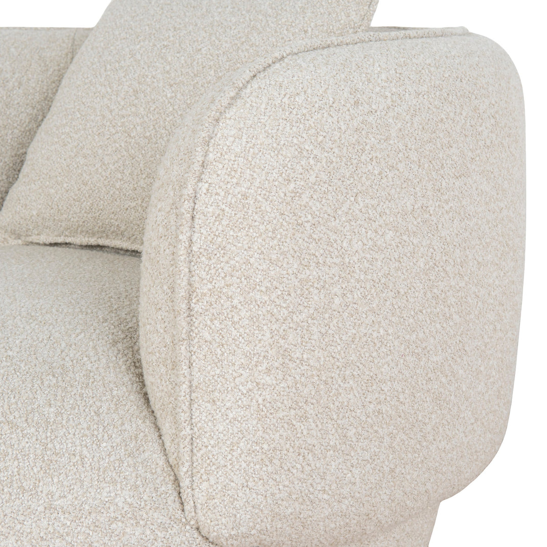 Front detail shot highlighting the thick cushioning and the low-profile wooden swivel base
