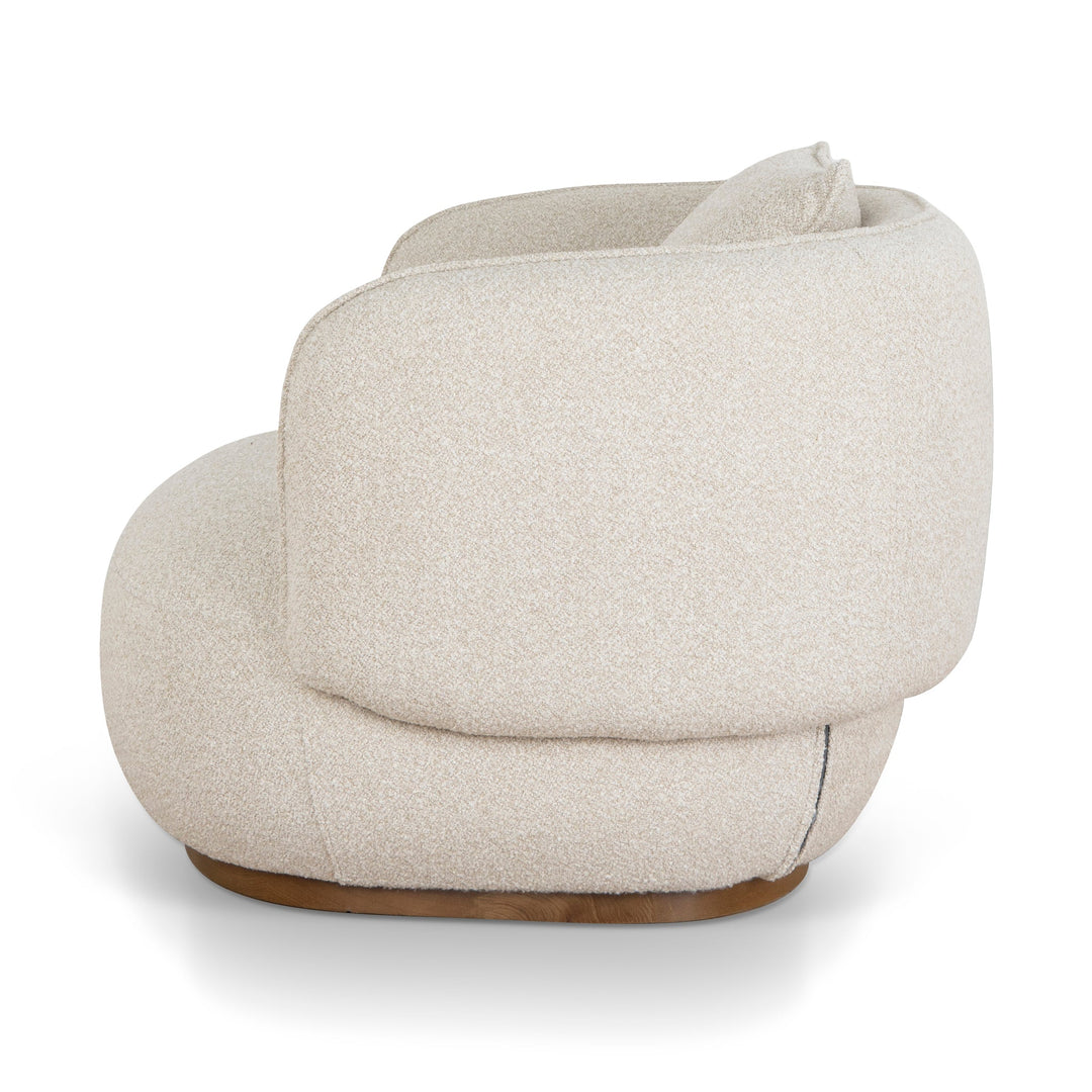Side profile highlighting the low-slung design and the elegant wrap-around backrest curvature