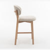 Side profile of the Luna counter stool highlighting the curved backrest and slim legs