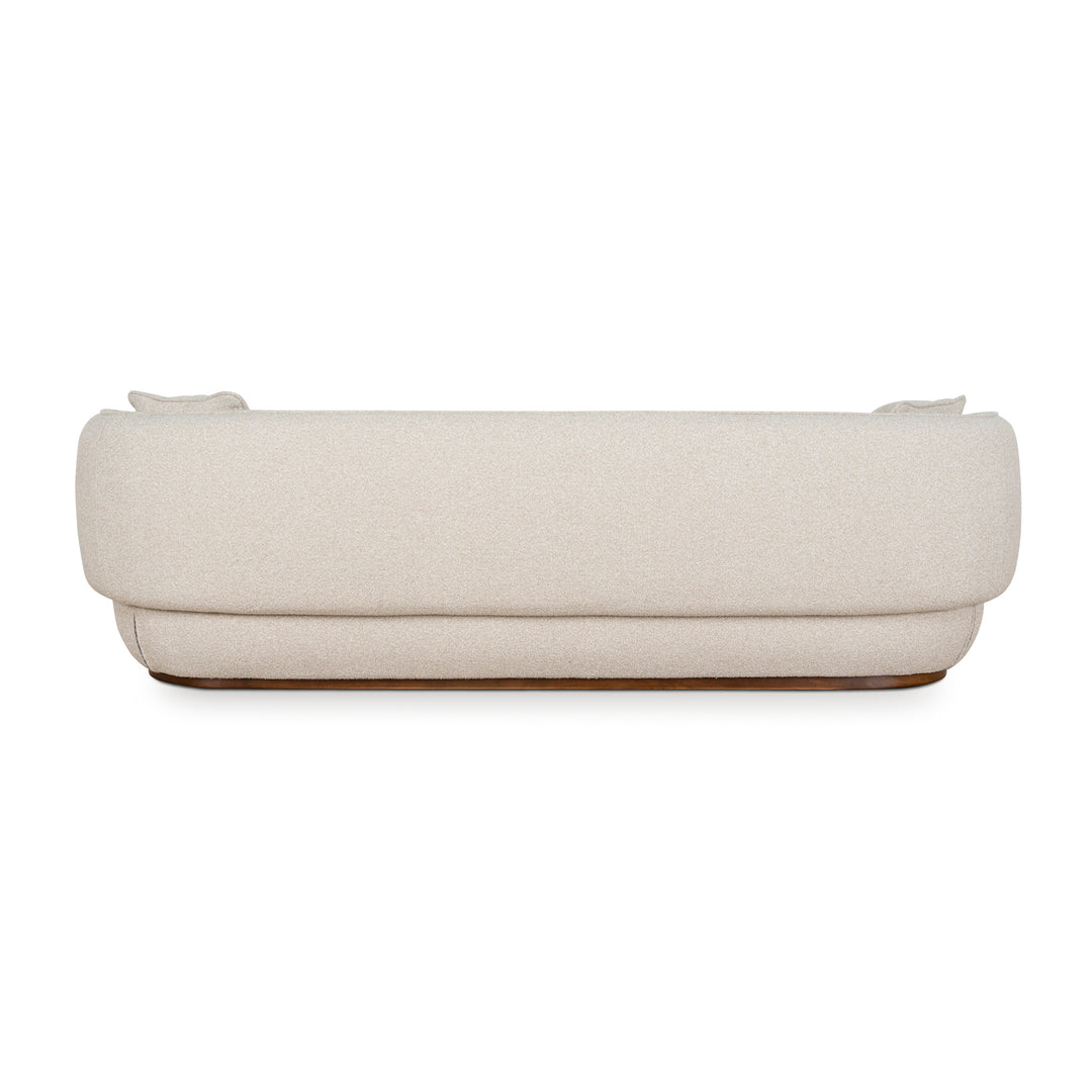 Back view of Luna Premium boucle sofa in cream fabric with curved backrest and modern low-profile wooden base