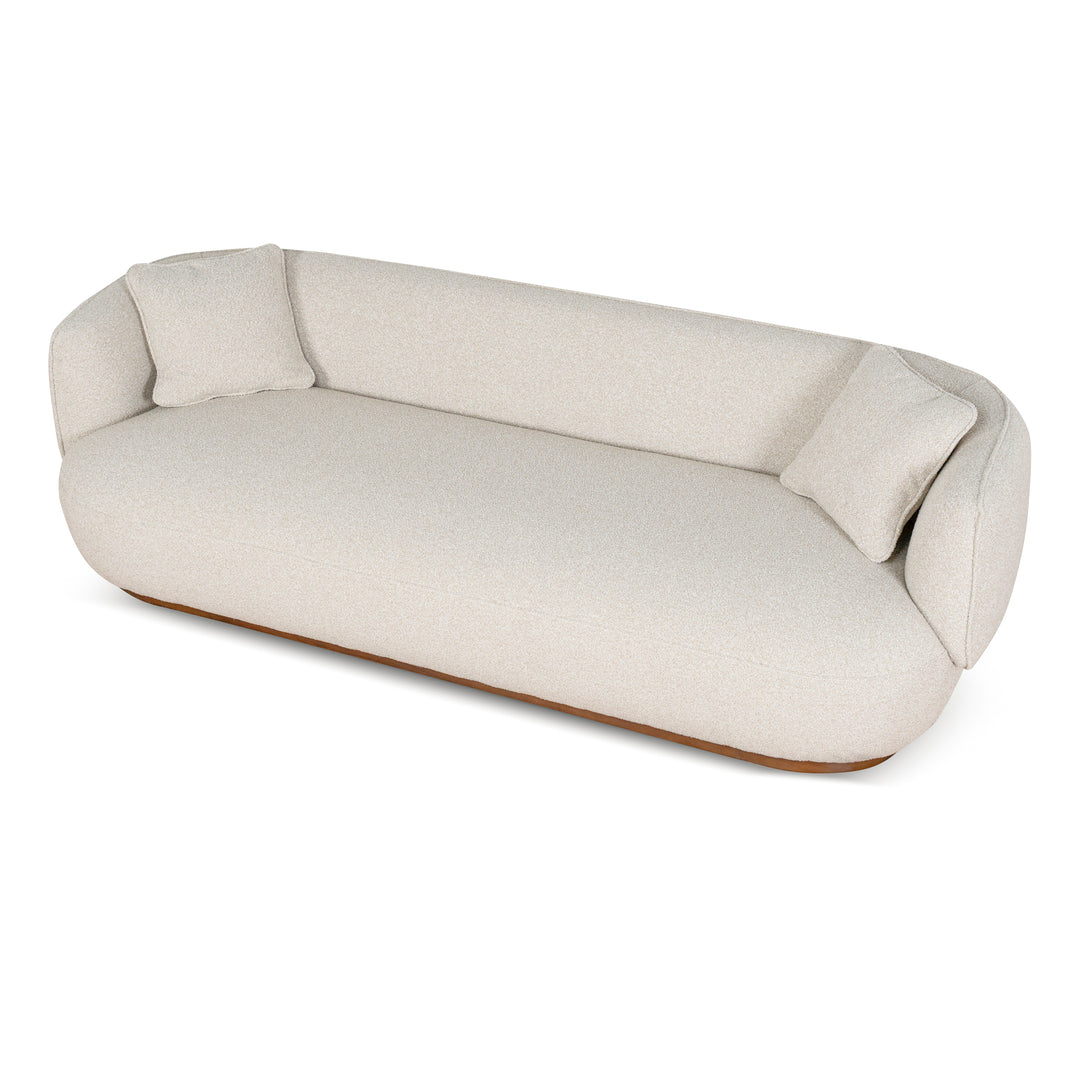 Luna Premium Boucle Sofa in cream boucle fabric with curved silhouette, two pillows, and low wooden base, angled view modern luxury sofa