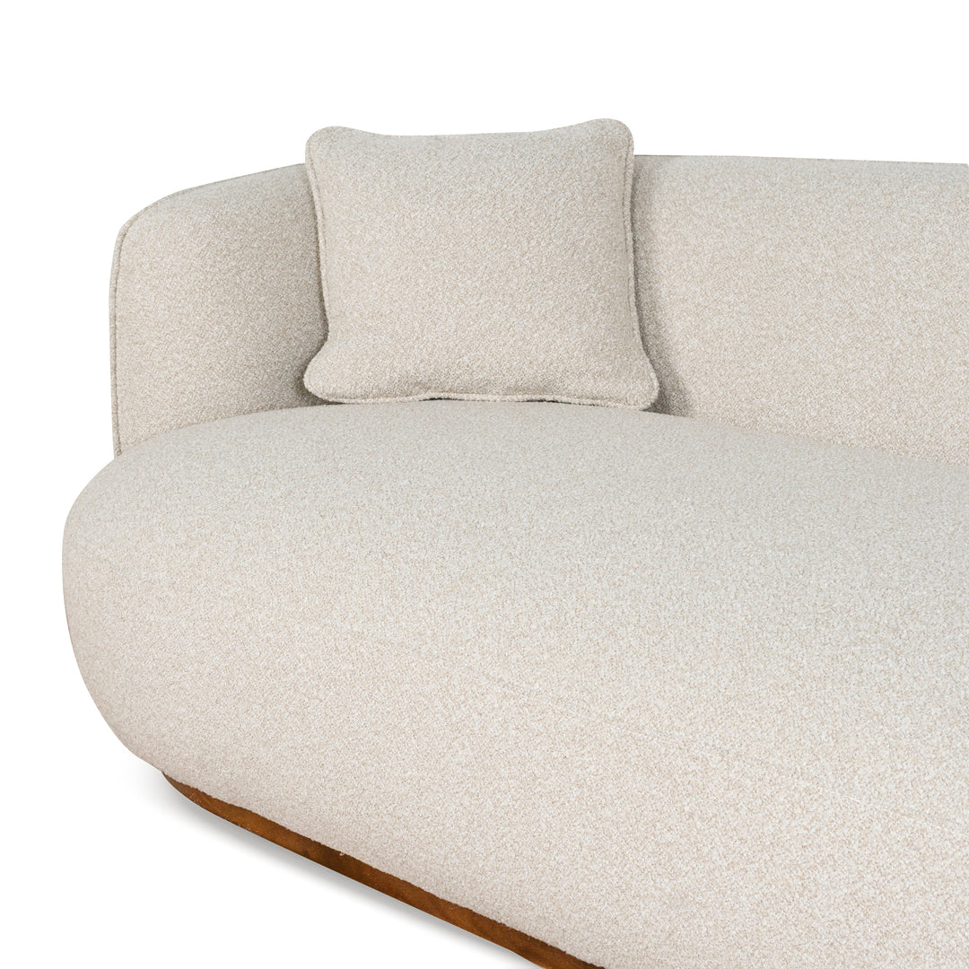 Close-up of Luna Premium Boucle Sofa in cream boucle fabric showing curved armrest, seat cushion, and matching pillow texture