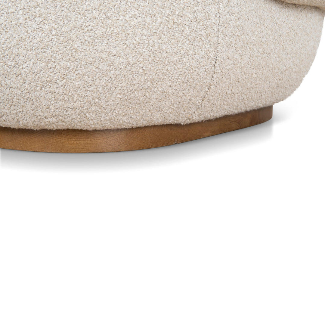 Close-up of the circular natural wood base that provides the 360-degree swivel functionality
