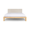 Front view of the Luna platform bed featuring a solid oak wood frame and a low-profile sand upholstered headboard