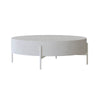 Front view of the Luna coffee table featuring a thick circular drum-style top in white concrete supported by a minimalist four-leg metal base