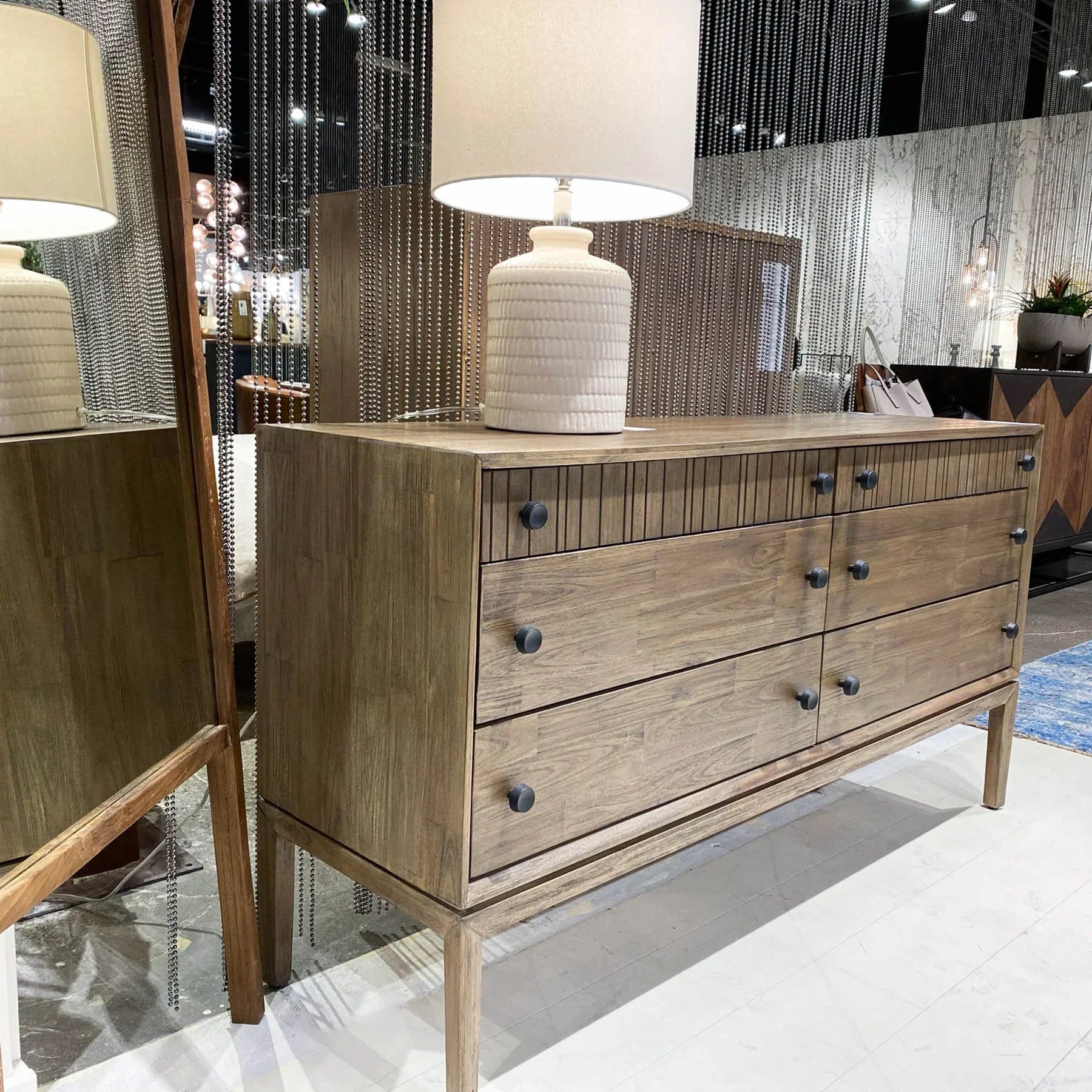 Front view of the West 6-drawer double dresser featuring a rich natural wood finish, dark circular knobs, and top drawers with vertical fluted detailing