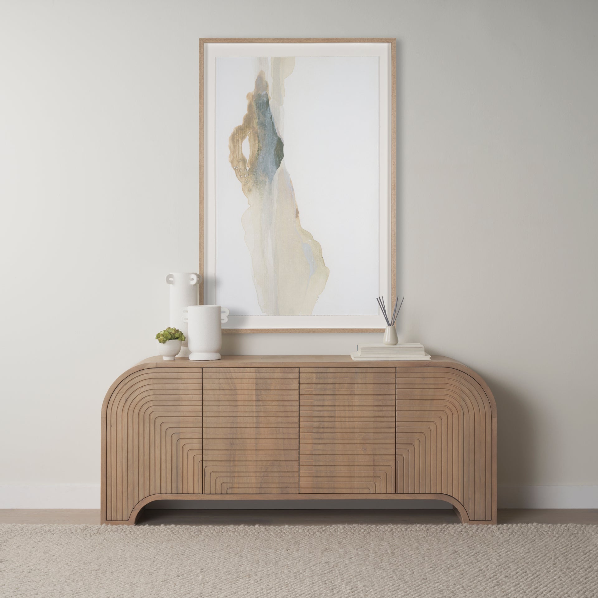 Front view of the Sorina sideboard featuring light brown wood construction with intricate reverse fluted door panels and an elegant arched base