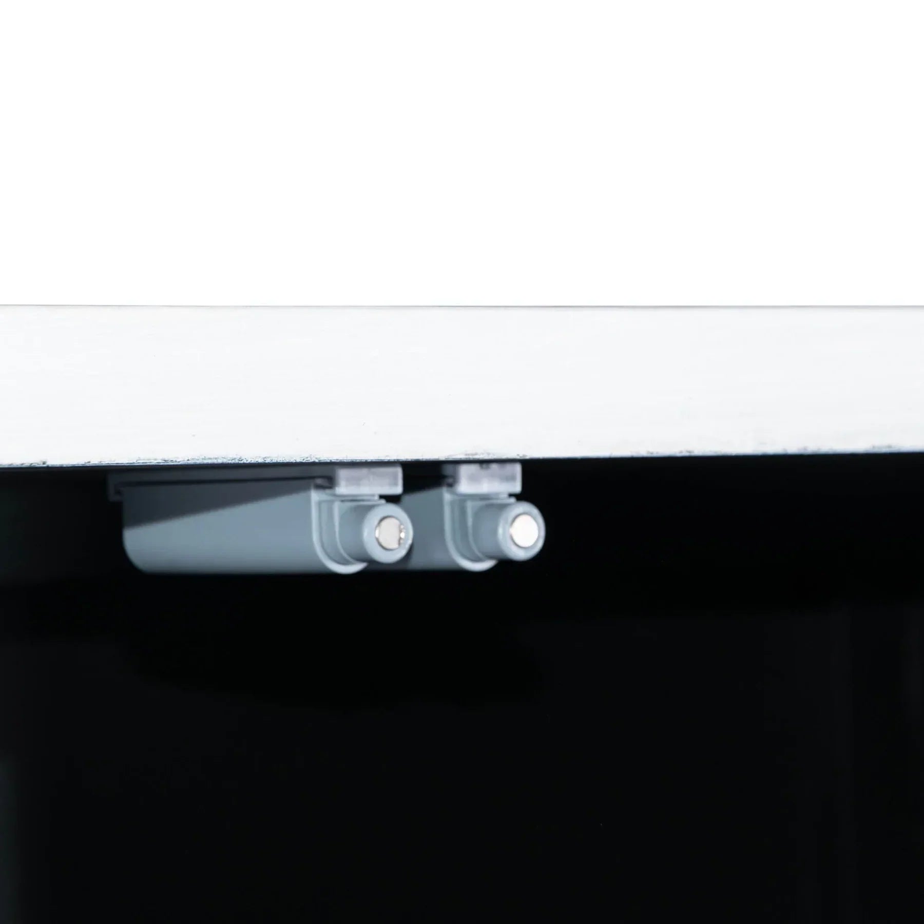 Three-quarter perspective view of the Caged sideboard featuring a sleek white frame, black metal-framed glass doors, and a minimalist black metal base