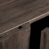 Macro shot focusing on the magnetic push-to-open latch system and the precision-cut vertical fluting on the cabinet doors