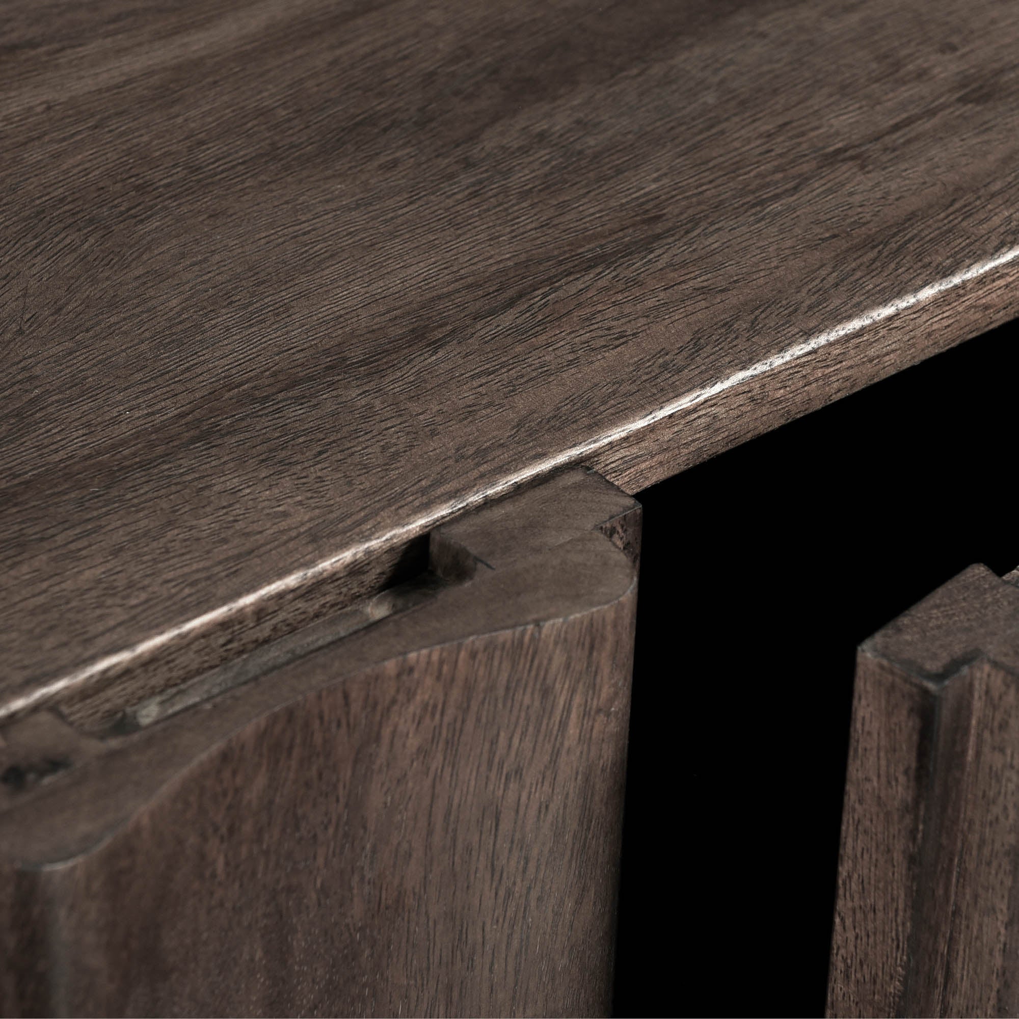 Straight-on front view highlighting the symmetrical vertical fluting and the seamless hardware-free aesthetic of the dark wood cabinet