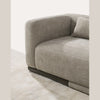 Side perspective showing the oversized rounded armrest and oak wood base