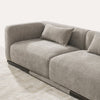 Angled close-up view of Malakai sofa seat cushions with taupe textured fabric upholstery and dark wood base detailing