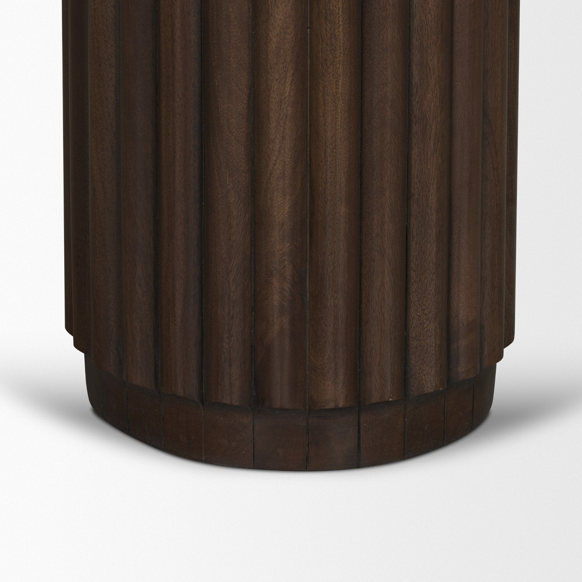 Close-up shot highlighting the deep vertical grooves and dark finish of the fluted pedestal support