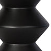 Close-up macro shot focusing on the subtle organic texture and seamless edges of the black concrete form