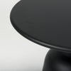 Close-up shot focusing on the smooth surface and clean rounded edge of the matte black metal tabletop