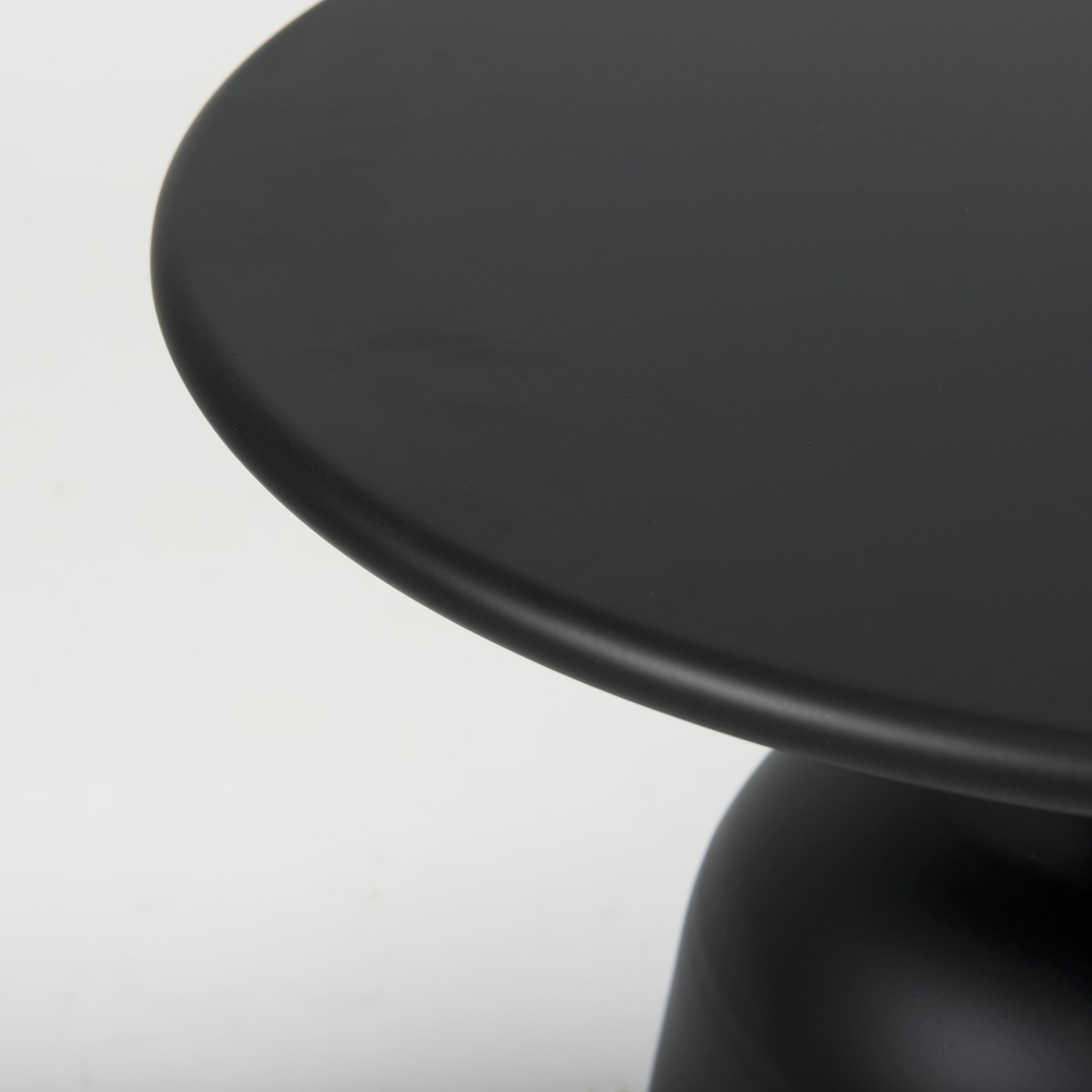 Front view of the Talulla accent table featuring a wide circular top and a bell-shaped pedestal base in a sleek matte black metal finish