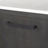 Macro shot focusing on the sleek matte black horizontal metal handles on the sideboard drawers