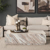 Lifestyle shot featuring the Matteo marble coffee table styled in a modern living room with a neutral sectional sofa