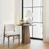 Lifestyle view of Maxine foyer table styled in a bright entryway with a chair