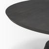 Close-up shot focusing on the smooth tapered edge of the round wood tabletop and charcoal finish