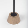 Detail of the tapered oak wood base and black metal joinery on the Maxwell table