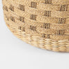 Detail shot of the lower curved edge showing the durable braided base construction of the seagrass footstool