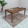 Perspective lifestyle shot featuring the table paired with contemporary chairs for a family seating arrangement