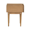 Side profile view emphasizing the slim tapered legs and the solid wood construction of the natural oak side table